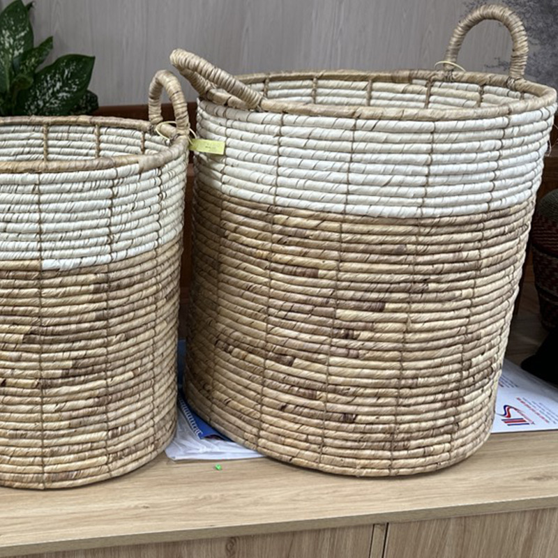 Handcrafted seagrass wall baskets, coasters with colored borders, and floor poufs showcasing intricate weaves